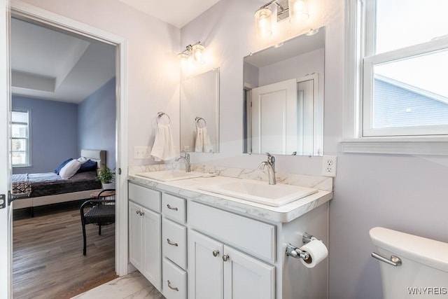 12 Kevwood Ln, Lancaster, NY 14086 - ensuite bathroom featuring double vanity, a sink, connected bathroom, and toilet