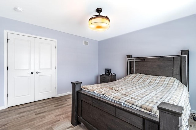 12 Kevwood Ln, Lancaster, NY 14086 - bedroom with baseboards, a closet, light wood finished floors, and visible vents