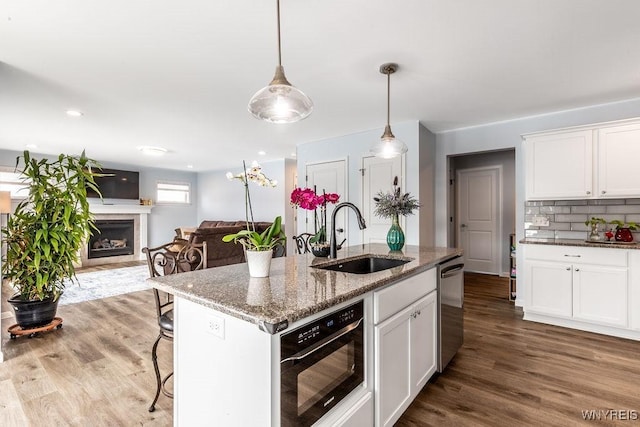 12 Kevwood Ln, Lancaster, NY 14086 - kitchen with wood finished floors, white cabinetry, a sink, and dishwasher