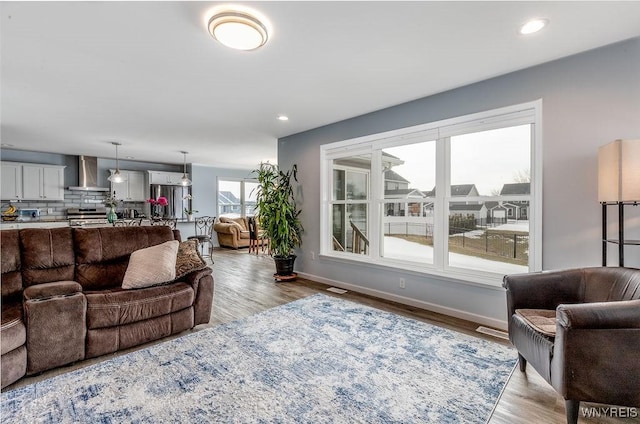 12 Kevwood Ln, Lancaster, NY 14086 - living room featuring recessed lighting, baseboards, visible vents, and wood finished floors