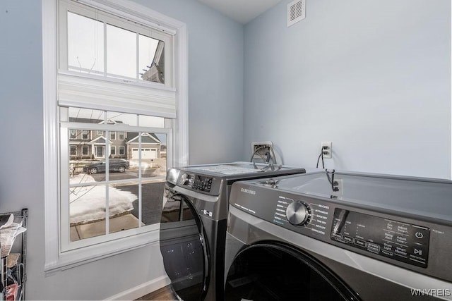 12 Kevwood Ln, Lancaster, NY 14086 - clothes washing area featuring washing machine and clothes dryer, laundry area, and visible vents