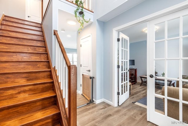 12 Kevwood Ln, Lancaster, NY 14086 - staircase with baseboards, french doors, and wood finished floors