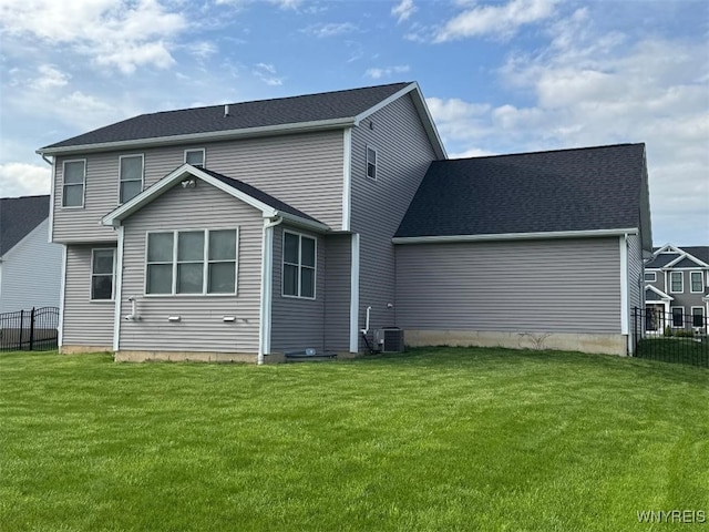 12 Kevwood Ln, Lancaster, NY 14086 - rear view of house featuring fence, a yard, and central AC