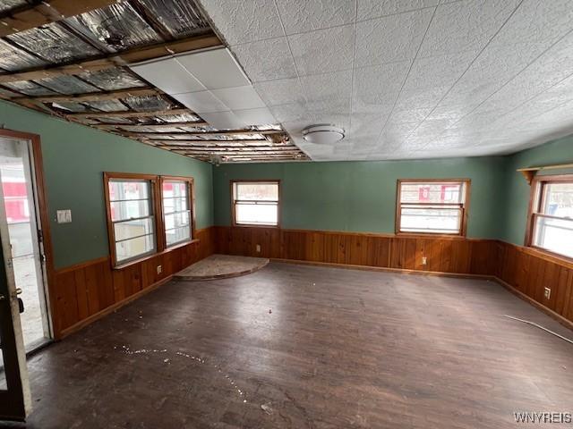 306 Plank Rd, Lockport-City, NY 14094 - empty room with a wainscoted wall, wood walls, and wood finished floors