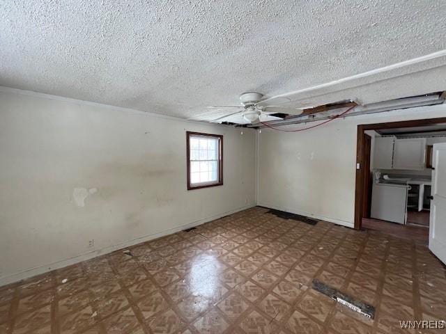 306 Plank Rd, Lockport-City, NY 14094 - empty room with a ceiling fan, a textured ceiling, washer / dryer, and baseboards