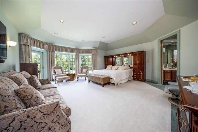 bedroom featuring recessed lighting, light colored carpet, baseboards, vaulted ceiling, and a tray ceiling