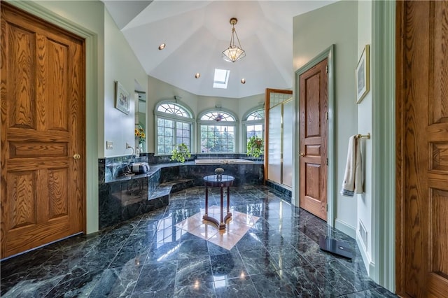 full bathroom with lofted ceiling with skylight, marble finish floor, walk in shower, and a bath