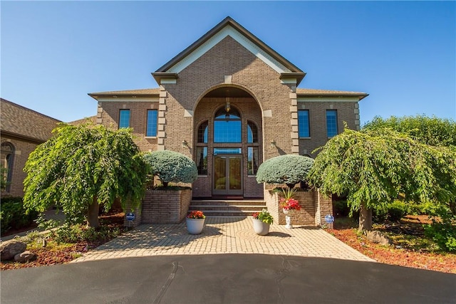 view of front facade featuring french doors and brick siding