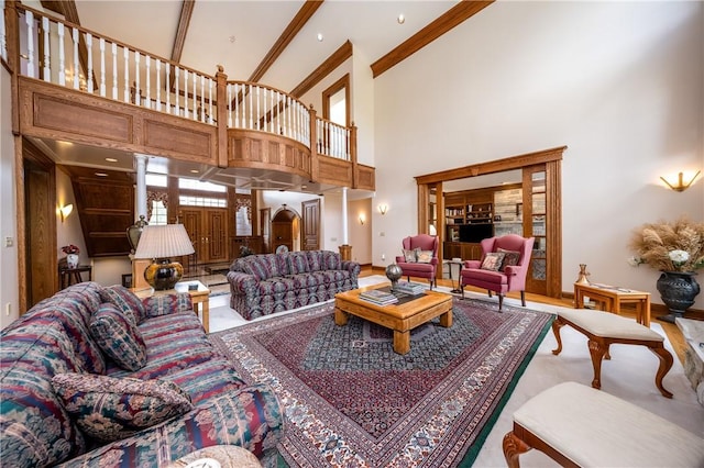 living area with ornamental molding and a towering ceiling