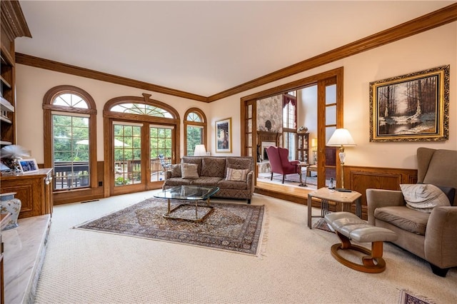 living area with ornamental molding and carpet flooring