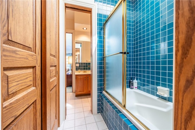 full bathroom with tiled shower / bath combo, tile patterned flooring, and vanity