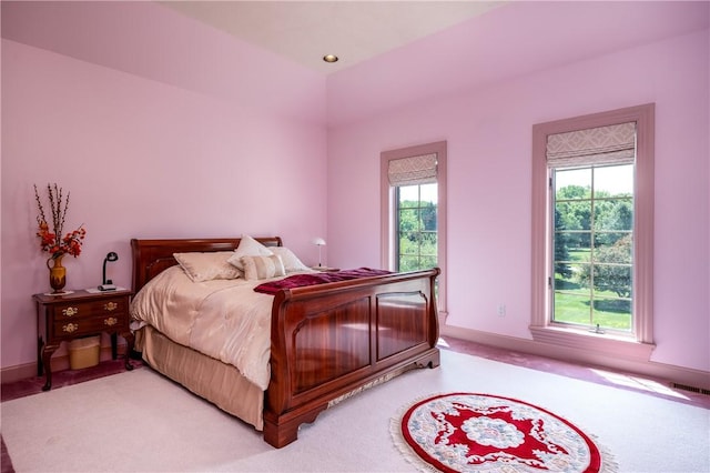 bedroom with baseboards, visible vents, and carpet flooring