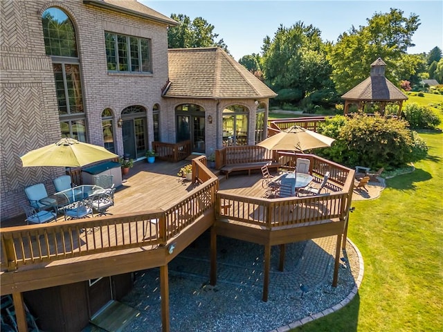 deck featuring a yard, outdoor dining space, and a gazebo