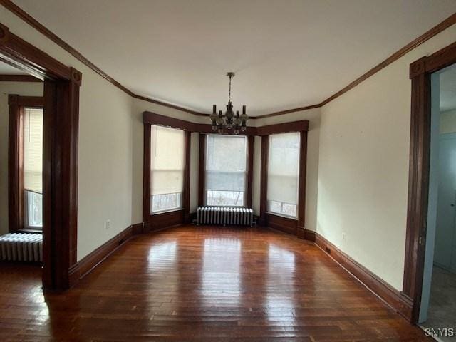 unfurnished dining area featuring radiator, a notable chandelier, baseboards, and wood finished floors