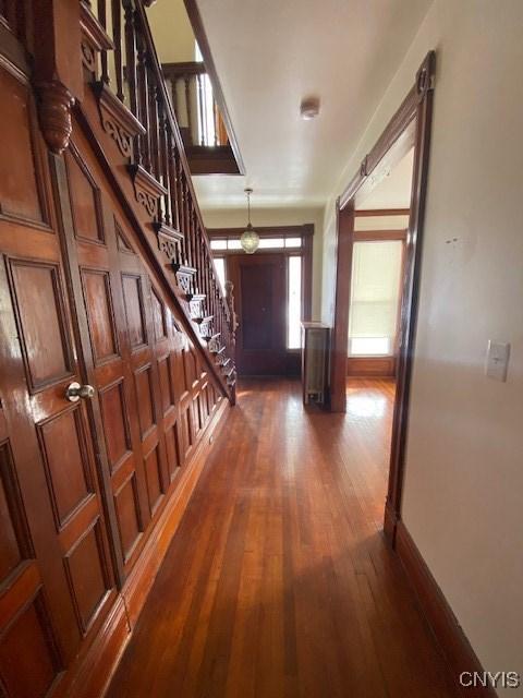 hall with stairs, dark wood finished floors, and baseboards