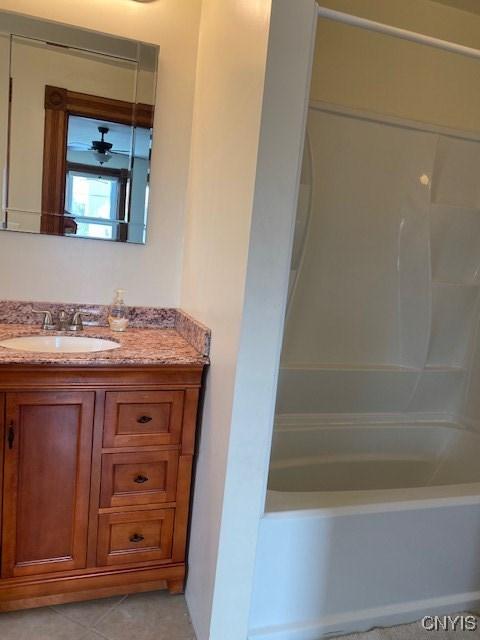 full bath featuring shower / washtub combination, tile patterned flooring, and vanity