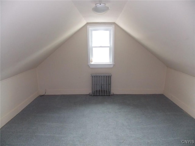 bonus room with radiator, carpet floors, and vaulted ceiling