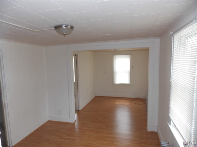 unfurnished room featuring light wood-type flooring and baseboards