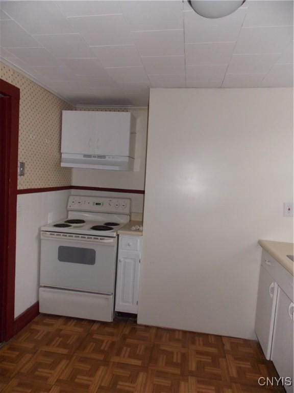 kitchen with wallpapered walls, white cabinets, wainscoting, white electric range, and under cabinet range hood