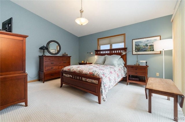 bedroom featuring light colored carpet and vaulted ceiling