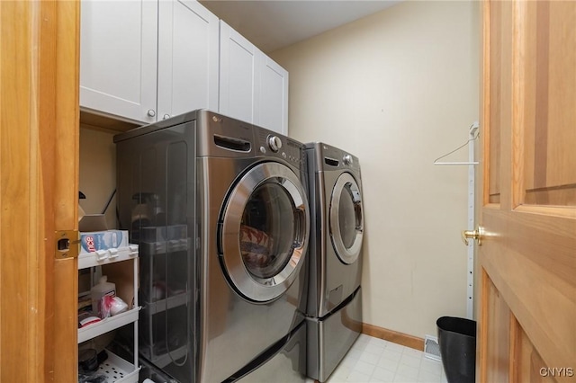 clothes washing area with light floors, baseboards, cabinet space, and washing machine and clothes dryer