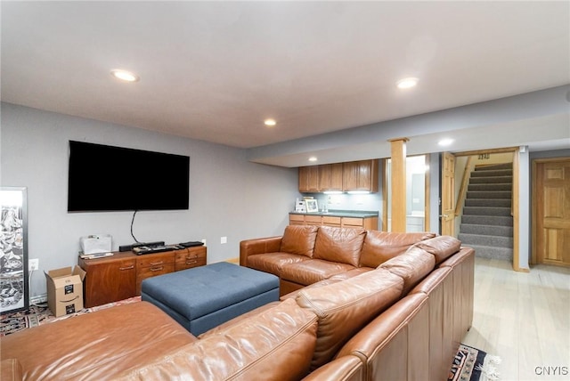 living area with light wood-style floors, stairway, and recessed lighting