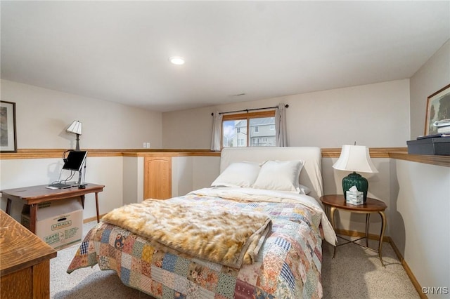 bedroom featuring light carpet and baseboards