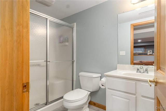 full bath featuring a stall shower, vanity, toilet, and baseboards