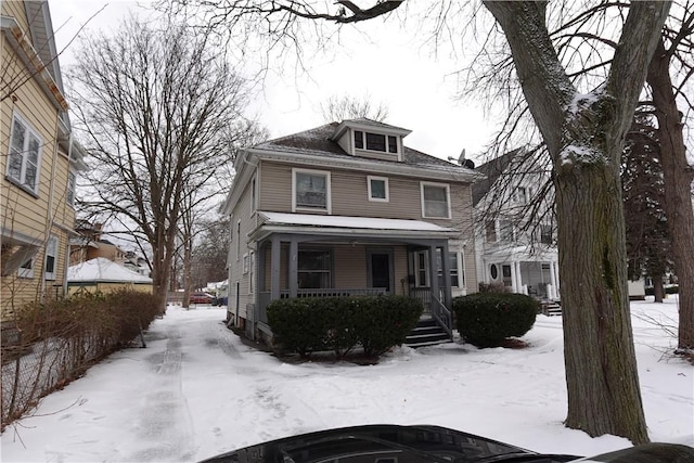 american foursquare style home featuring a porch