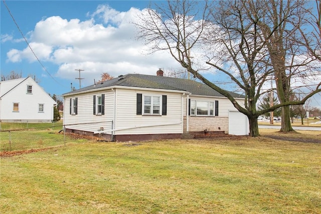 exterior space with a chimney, a lawn, fence, a garage, and stone siding