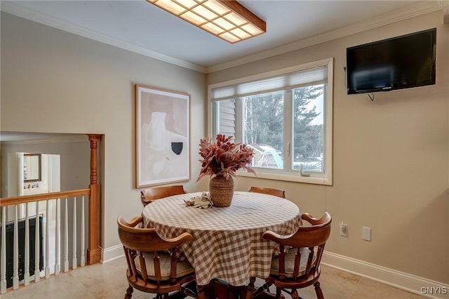 dining area featuring crown molding, baseboards, and light tile patterned floors