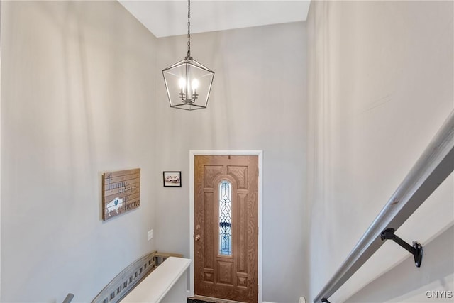 foyer entrance featuring a notable chandelier