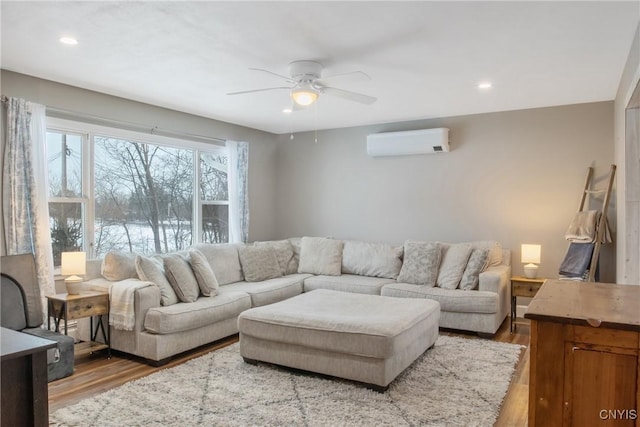 living area featuring recessed lighting, ceiling fan, wood finished floors, and a wall mounted air conditioner