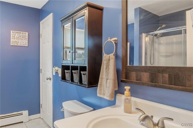 full bath with toilet, a shower with door, tile patterned floors, vanity, and a baseboard heating unit