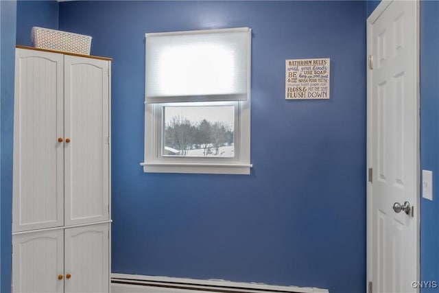 unfurnished bedroom featuring a baseboard radiator and a closet