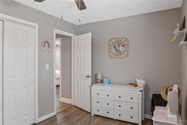 bedroom featuring baseboards, a ceiling fan, and wood finished floors