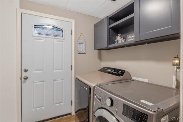 laundry area featuring washing machine and dryer and cabinet space