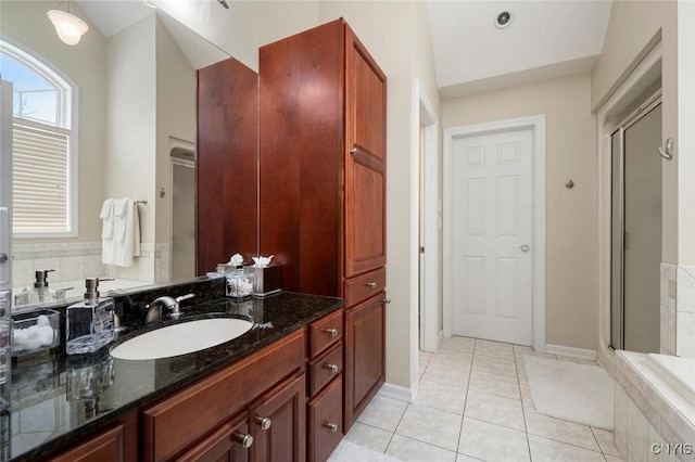 full bath featuring a stall shower, vanity, and tile patterned floors