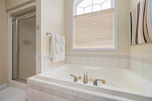 bathroom with a tub with jets and a shower stall