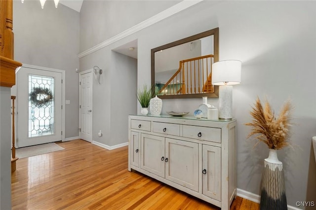 foyer entrance featuring light wood-style floors and baseboards