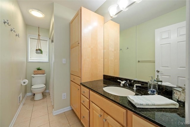 bathroom with toilet, tile patterned flooring, vanity, and baseboards