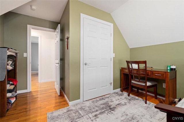 office with vaulted ceiling, baseboards, and wood finished floors