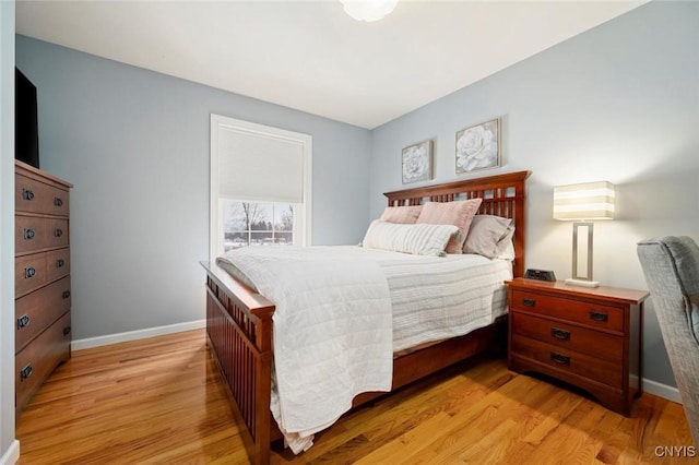 bedroom featuring light wood-style flooring and baseboards