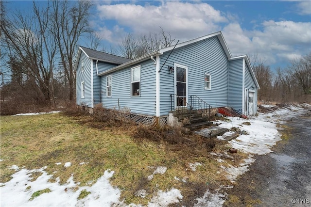 snow covered property with entry steps