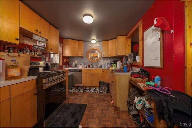 kitchen featuring a sink, stainless steel appliances, and light countertops