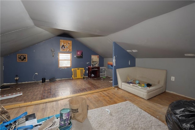 bonus room featuring vaulted ceiling, wood finished floors, and baseboards