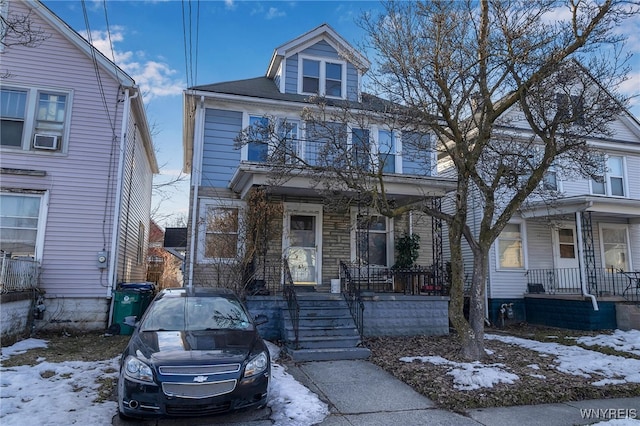 american foursquare style home featuring a porch