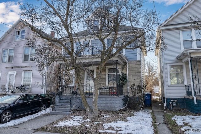 american foursquare style home with covered porch