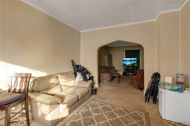 living room with arched walkways, carpet floors, baseboard heating, and crown molding