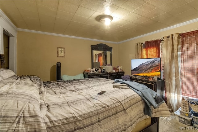 bedroom with ornamental molding and carpet floors